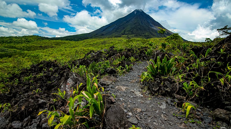 This image shows the Arenal Volcano, an iconic and symmetrically shaped andesitic stratovolcano located in the Arenal Volcano National Park near La Fortuna, Costa Rica.