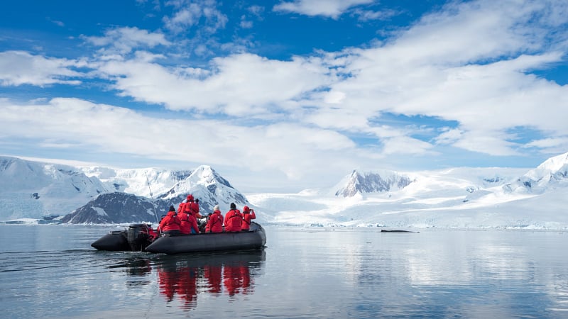 Inflatable boat full of tourists, watching for whales and seals, Antarctic Peninsula, Antarctica