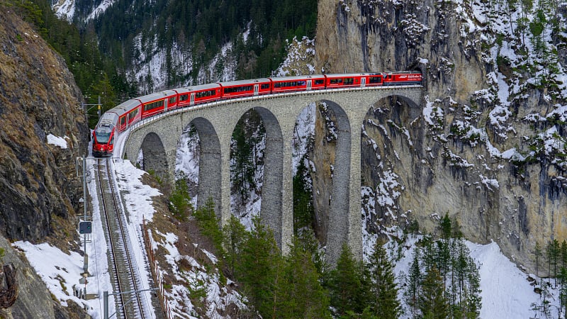 The world-famous Landwasser Viaduct, an iconic curved railway bridge located near Schmitten and Filisur in the canton of Graubünden, Switzerland.