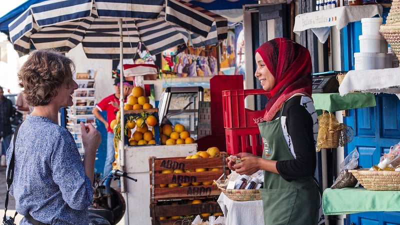 Colors of Morocco, A Moroccan woman selling fruits and herbs at the busy outdoor market in Rabat, Morocco