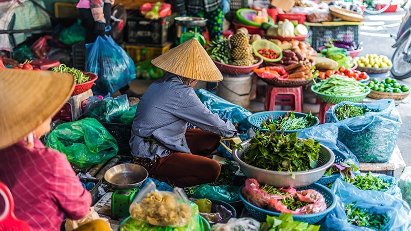 Women selling food on the street of Hoi An, Vietnam
