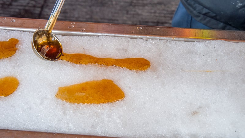 Maple taffy on snow, a traditional Canadian and New England winter treat. In French-speaking regions like Quebec, it is known as tire d'érable.