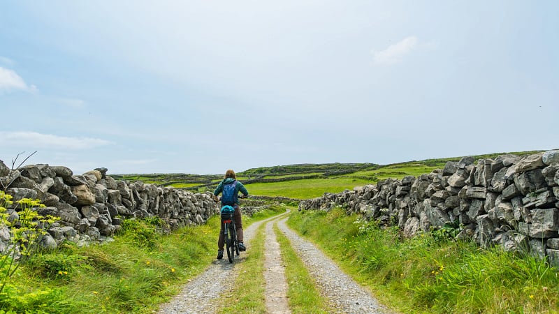 Riding a bike on dirt road, Aran Islands