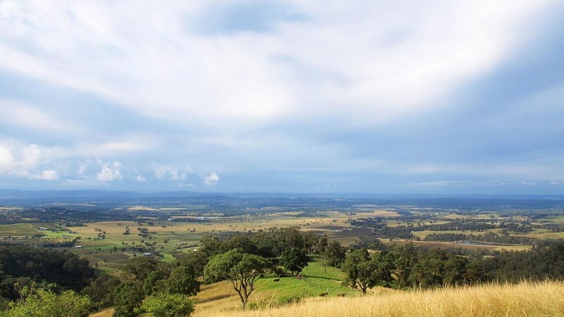 This image captures the sweeping panoramic view from the Hang Gliders Lookout, situated on the western escarpment of Tamborine Mountain in Queensland, Australia.
