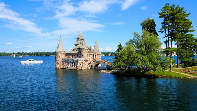 This is the Power House and Clock Tower, a famous medieval-style stone structure located on the eastern edge of Heart Island in the Thousand Islands region of New York.