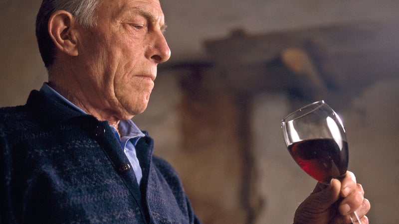 Man looking at red wine chianti