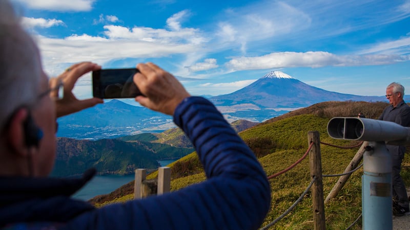 Man taking a picture of Mt Fuji
