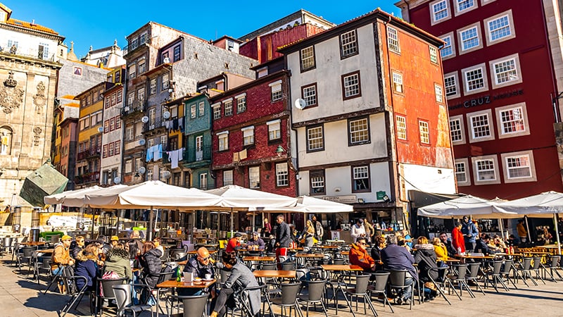 Porto Ribeira Square, Porto Picturesque View of People at Restaurants and Cafes on a Sunny Blue Sky Day
