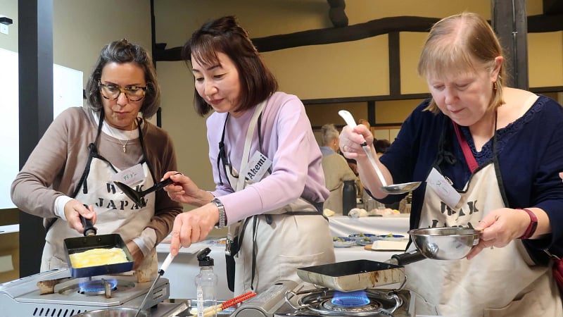 Travelers participating in a hands-on Japanese cultural cooking class