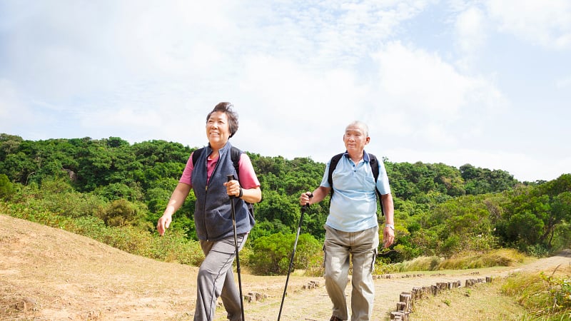 A couple hiking on a dirt path