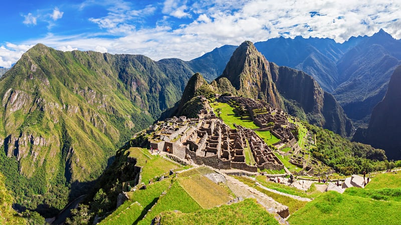 Machu Picchu is a 15th-century Inca citadel situated on a mountain ridge in Peru.