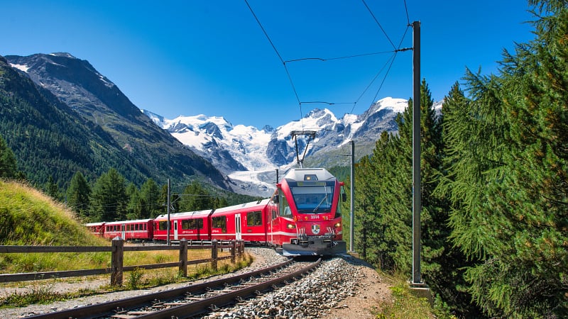 The famous Bernina Express, a historic and scenic panoramic train operated by the Rhaetian Railway in Switzerland.