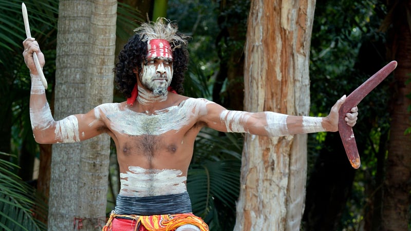 Yugambeh Aboriginal warrior participating in a cultural performance or martial arts demonstration in Queensland, Australia.