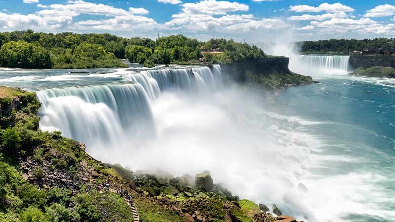 This image shows Niagara Falls, a world-famous group of three massive waterfalls straddling the international border between the United States and Canada.