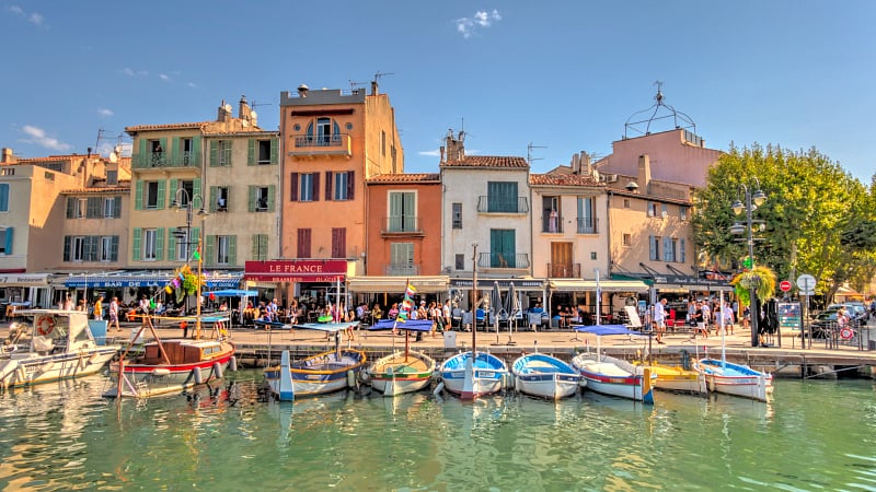 The waterfront of the Port de Cassis, a historic fishing port located in the charming coastal village of Cassis, France.