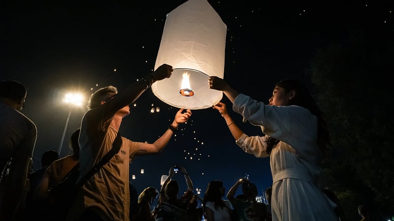 Rice paper lanterns, khom loy, are released into the night sky.