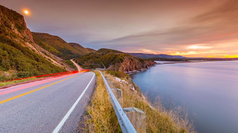 The image shows the Cabot Trail, a world-famous scenic highway located on Cape Breton Island in Nova Scotia, Canada.
